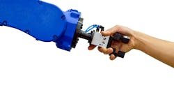 Industrial robot shaking hands with a human