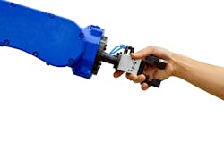 Industrial robot shaking hands with a human Industrial robot shaking hands with a human