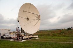 A microwave dish transmitter points toward a rectifying antenna in part of the SCOPE-M demonstration at Army Blossom Point Research Field. A microwave dish transmitter points toward a rectifying antenna in part of the SCOPE-M demonstration at Army Blossom Point Research Field.