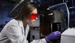 Lawrence Livermore National Laboratory researcher Caitlyn Cook characterizes the curing kinetics of a nanocomposite silica glass resin using light.