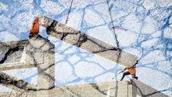 Concrete beam being lowered Concrete beam being lowered