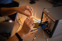 A developer works with a toolbox-sized prototype for a software-defined system called Multi-Mission Radio Frequency Architecture. A developer works with a toolbox-sized prototype for a software-defined system called Multi-Mission Radio Frequency Architecture.