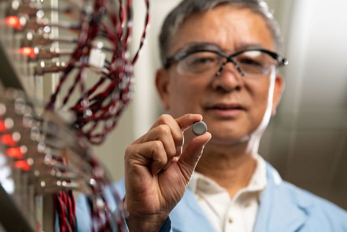 Battery expert Jiguang (Jason) Zhang holds an experimental sodium-ion battery that is more stable and reliable than current sodium-ion battery technology.