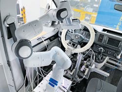 The VW van undergoing tests has a robot and linear motors that activate vehicle controls as it undergoes simulated driving conditions. The VW van undergoing tests has a robot and linear motors that activate vehicle controls as it undergoes simulated driving conditions.