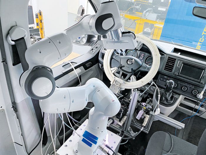 The VW van undergoing tests has a robot and linear motors that activate vehicle controls as it undergoes simulated driving conditions.