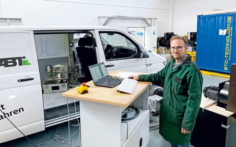 A technician runs the test bench at the University of HS Kempten that can run 24/7 to evaluate gas-powered vehicles which have been converted to run on electricity such as this VW van.