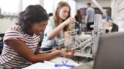 Students building a machine in an engineering class