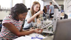 Students building a machine in an engineering class Students building a machine in an engineering class