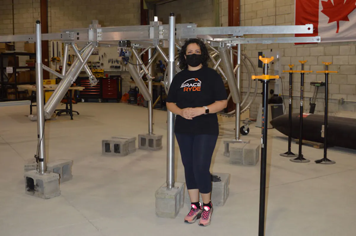Saharnaz Safari stands in front of the aluminum Flying Spider rocket carrier