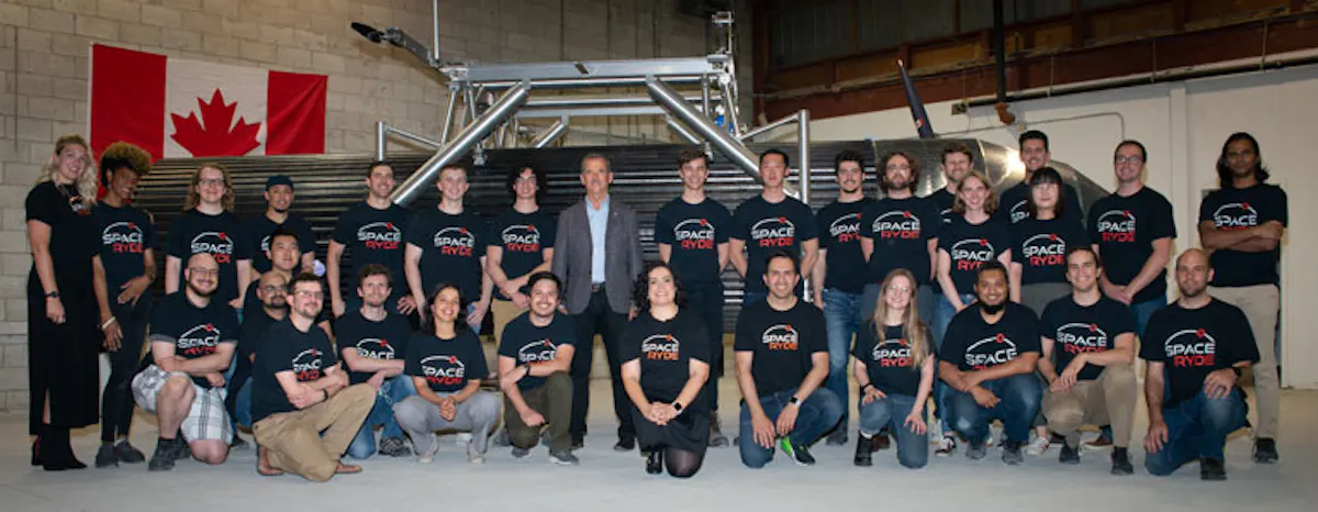 SpaceRyde engineering team poses with Chris Hadfield in its factory
