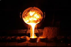 Molten metal being poured in a foundry Molten metal being poured in a foundry
