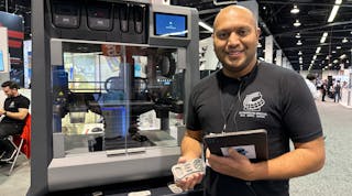 Axel Fernandes, additive manufacturing solutions lead with CAD/CAM Consulting Services, demonstrates the relationship between software, a Desktop Metal Studio 3D printer and the part he holds in his hand.