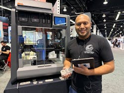Axel Fernandes, additive manufacturing solutions lead with CAD/CAM Consulting Services, demonstrates the relationship between software, a Desktop Metal Studio 3D printer and the part he holds in his hand. Axel Fernandes, additive manufacturing solutions lead with CAD/CAM Consulting Services, demonstrates the relationship between software, a Desktop Metal Studio 3D printer and the part he holds in his hand.