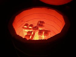 To investment cast several parts at once, a “tree” of individual molds connected via spues and tubes is heated to remove the wax patterns that form the molds. Later, when the ceramic molds have cooled, molten ,metal will be poured into the multi-mold assembly. To investment cast several parts at once, a “tree” of individual molds connected via spues and tubes is heated to remove the wax patterns that form the molds. Later, when the ceramic molds have cooled, molten ,metal will be poured into the multi-mold assembly.