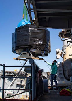 A sailor coordinates the loading of a 3D printer/CNC milling machine aboard the Wasp-class amphibious assault ship USS Bataan (LHD 5). This will be the first hybrid system installed on a U.S. Navy ship and will give its crew additive and subtractive steel manufacturing capabilities. A sailor coordinates the loading of a 3D printer/CNC milling machine aboard the Wasp-class amphibious assault ship USS Bataan (LHD 5). This will be the first hybrid system installed on a U.S. Navy ship and will give its crew additive and subtractive steel manufacturing capabilities.