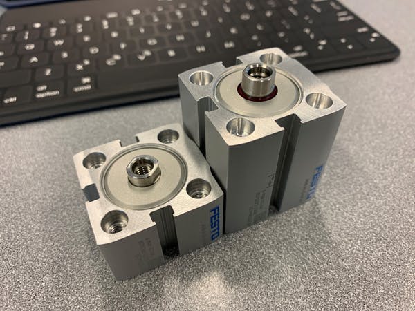 An ultra-compact Festo ADN-S cylinder, left, is considerably smaller compared to a compact ADN cylinder.