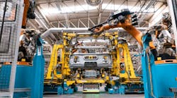 Mobile platforms transport truck cabins in and out of a welding cell. Mobile platforms transport truck cabins in and out of a welding cell.