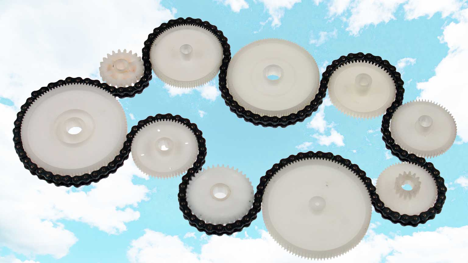 White plastic cogwheels and metal chain