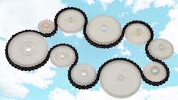 White plastic cogwheels and metal chain White plastic cogwheels and metal chain