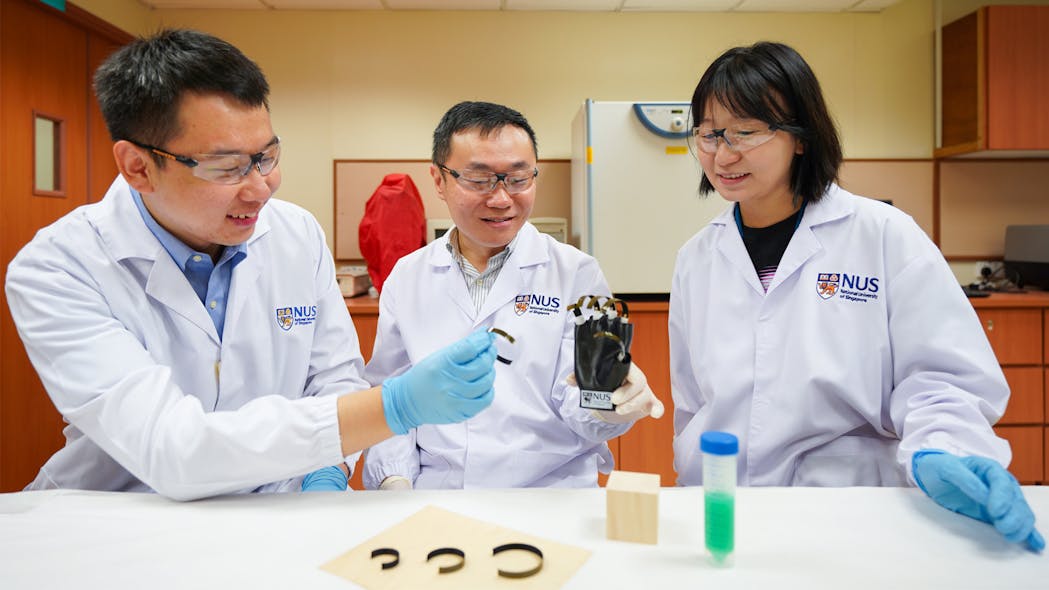 A research team from the National University of Singapore led by Assistant professor Tan Swee Ching (center) developed a wooden gripper that is driven by changes in moisture, temperature and lighting in the environment. His team members include Laboratory Technologist Qu Hao (left) and NUS doctoral student Bai Lulu (right).