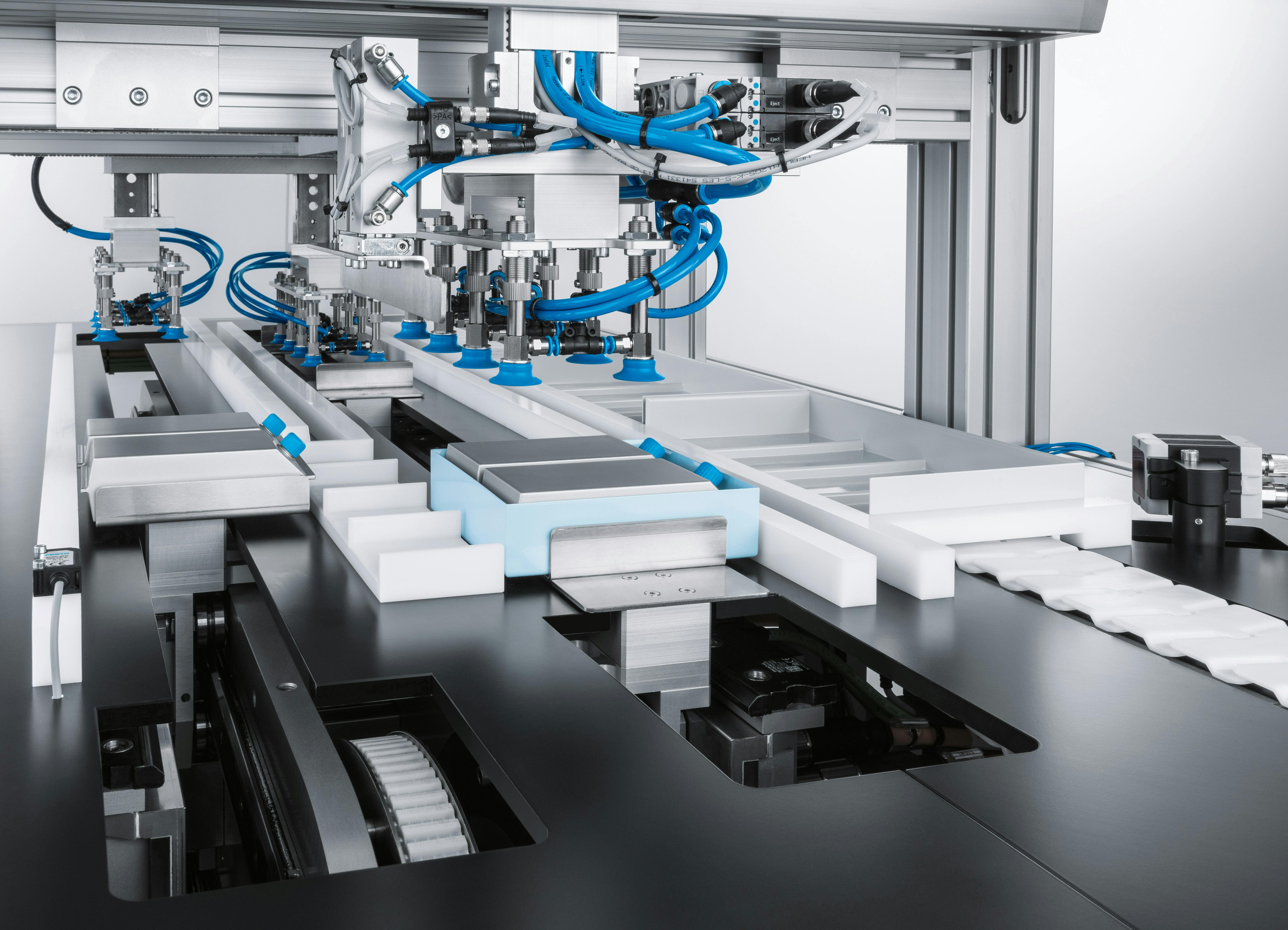 Multi-head Festo Cartesian robot performs picking-and-placing actions.