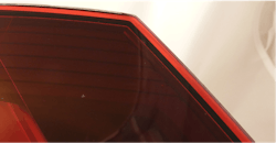 Close-ups of laser weld of automotive rear lamp through red lens.