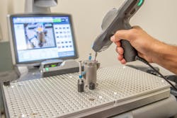 A part that was manufactured using direct metal laser sintering (DMLS) is being digitally inspected. A part that was manufactured using direct metal laser sintering (DMLS) is being digitally inspected.