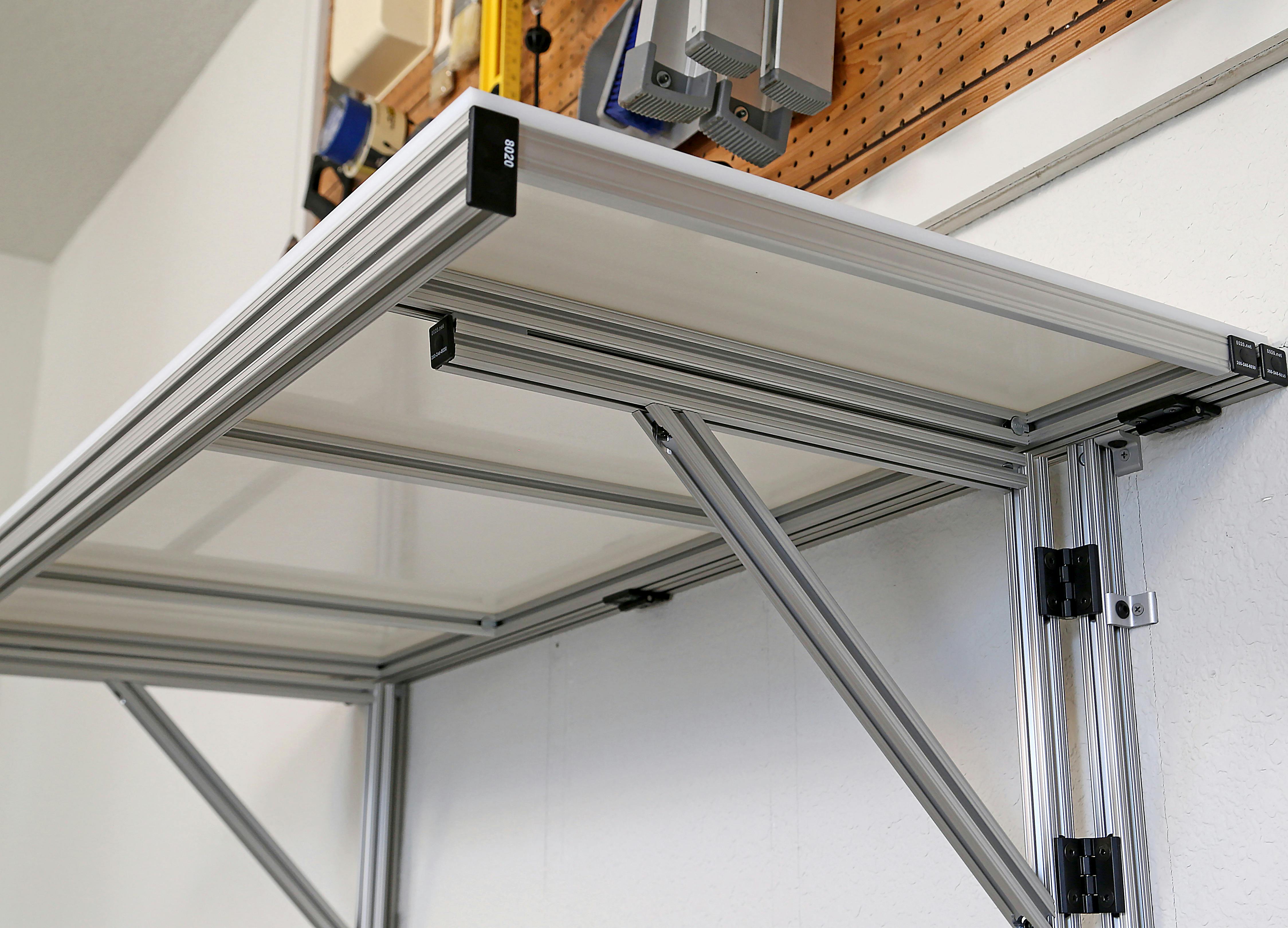 Figure 1. This DIY shelf features a 1̎ &times; 3 in. grooved extrusion with black endcaps and hinges. Image courtesy of 80/20.