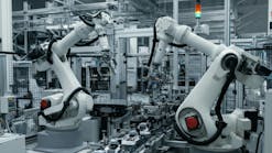 Industrial robotic arms working on an automated assembly line Industrial robotic arms working on an automated assembly line