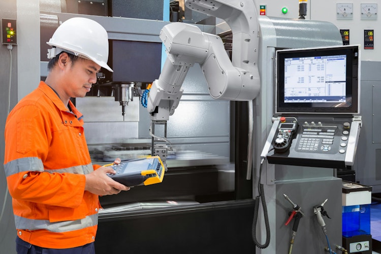 Maintenance engineer programming automatic robotic hand