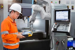 Maintenance engineer programming automatic robotic hand Maintenance engineer programming automatic robotic hand