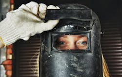 Woman wearing welding helmet Woman wearing welding helmet