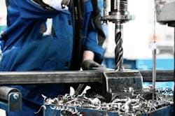 Industrial tehnician working on a drilling machine Industrial tehnician working on a drilling machine