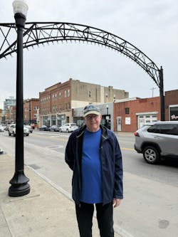 Christine Rice's dad posing in front of the archways and light poles he helped design Christine Rice's dad posing in front of the archways and light poles he helped design