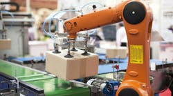 Packaging line with robotic arm at work. Packaging line with robotic arm at work.