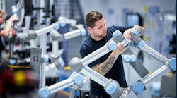 Technician working on industrial robiot Technician working on industrial robiot