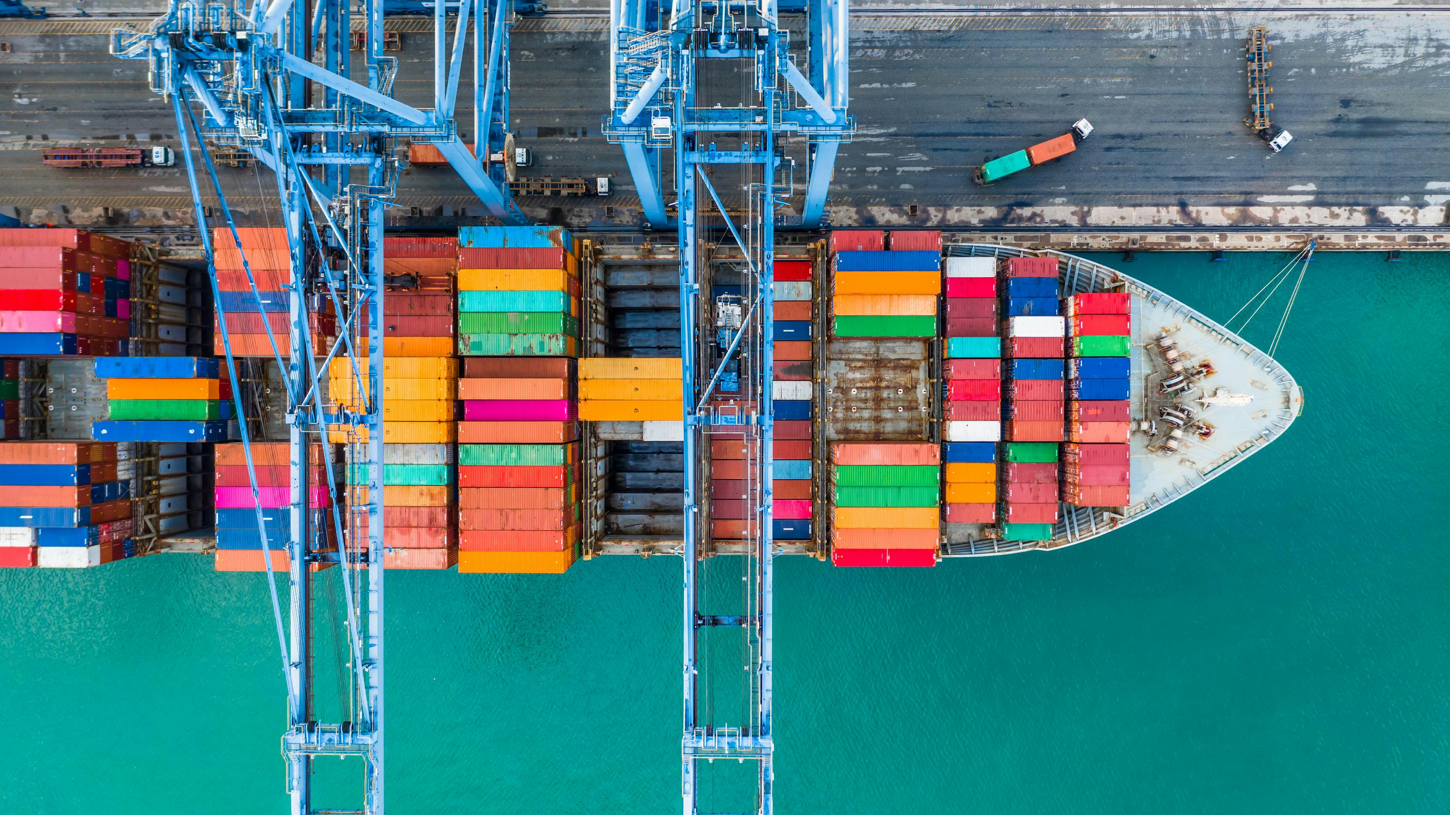Aerial top view of a crane and shipping container