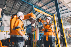 Workers and robot working side-by-side. Workers and robot working side-by-side.