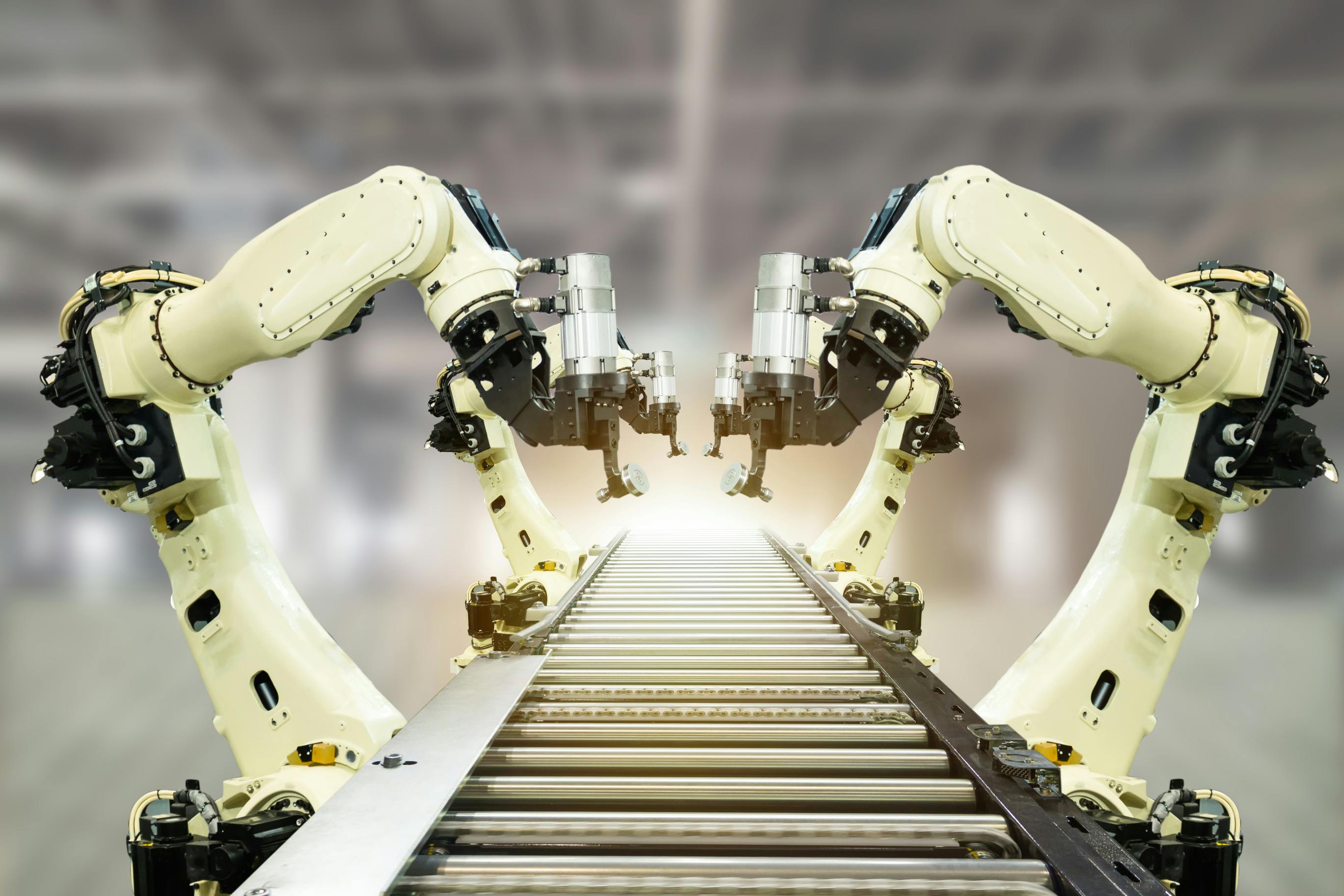 Robotic arms on conveyor belt